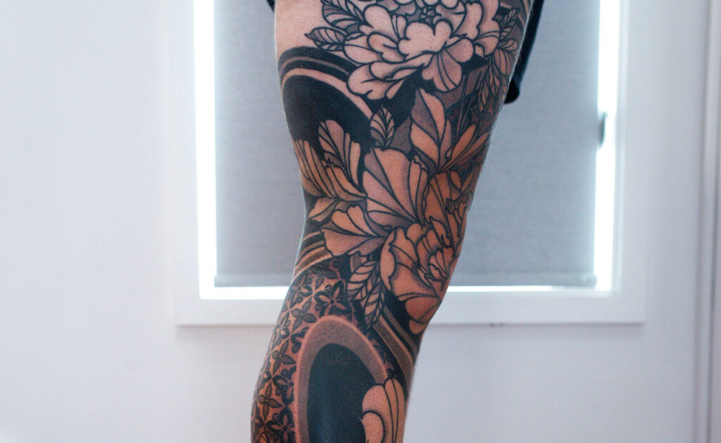 Kuhn's Full Floral and Black Work Leg, floral and black work tattoo by Simon Halpern, Kāneʻohe, Oahu